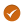 An orange circle with a checkmark icon