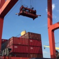 Shipped.com - Loading shipping containers onto a ship at the Cambodian port of Sihanoukville